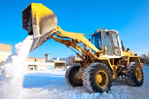 Front end loader dumping out snow